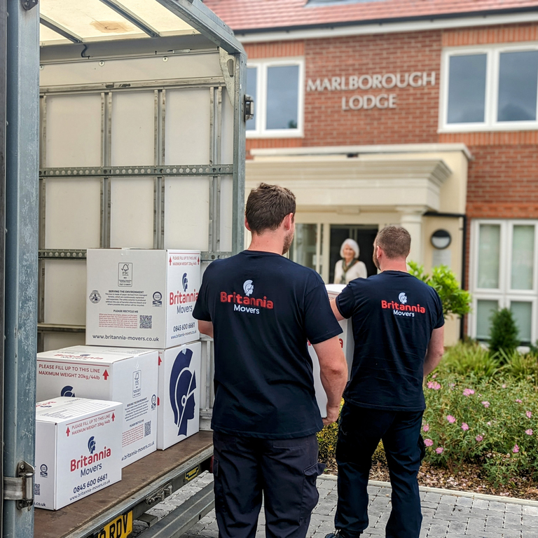 Team of Bradshaw International of Manchester movers carefully loading furniture into a van at a Greater Manchester property.